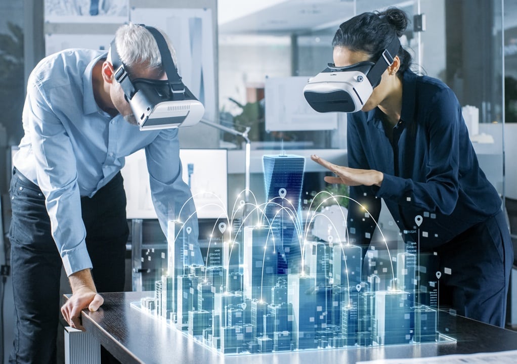 Male and Female Architects Wearing  Augmented Reality Headsets Work with 3D City Model. High Tech Office Professional People Use Virtual Reality Modeling Software Application.